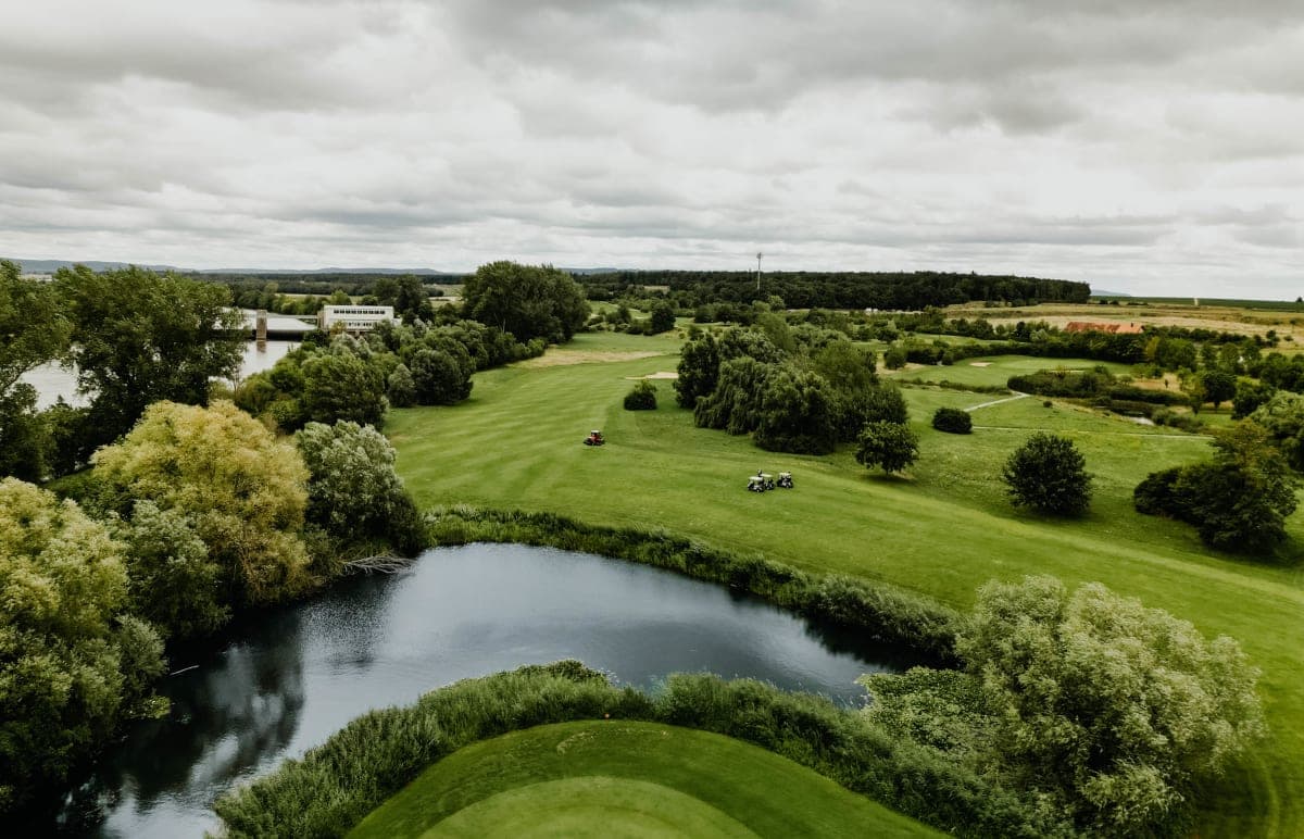 Aerial view of a golf course with pond and fairways in Franconia